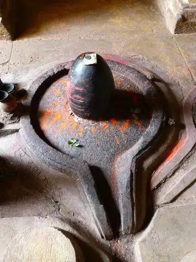 An Egg-shaped Lingam Placed on a Pedestal with a Spout